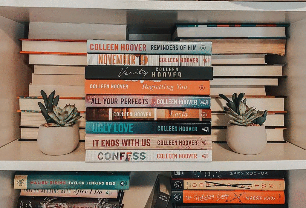 Stack of Colleen Hoover bestselling romance novels including It Ends with Us showing BookTok author success