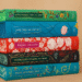 Stack of classic literature books including Pride and Prejudice, Jane Eyre, Emma, and Wuthering Heights with ornate vintage covers