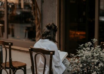 Woman Reading outside showing how Readers Respond to First Person vs Third Person Writing