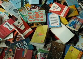 "Stack of unfinished books representing the journey from TBR to DNF for readers