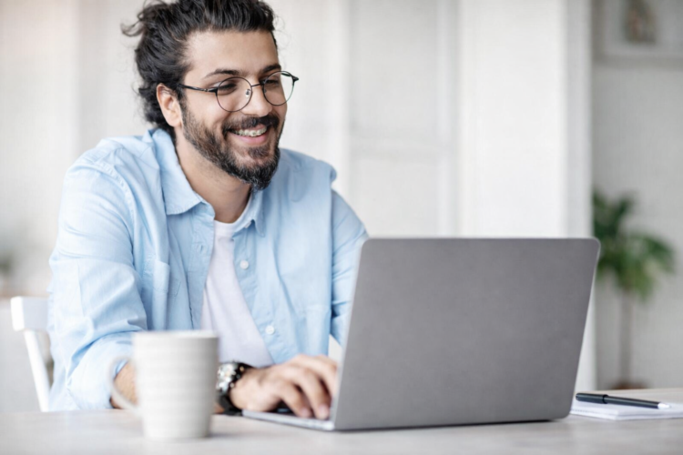 Professional author working at desk with laptop, representing the reality of author income and writing as a business