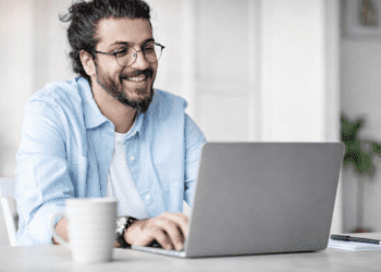 Professional author working at desk with laptop, representing the reality of author income and writing as a business
